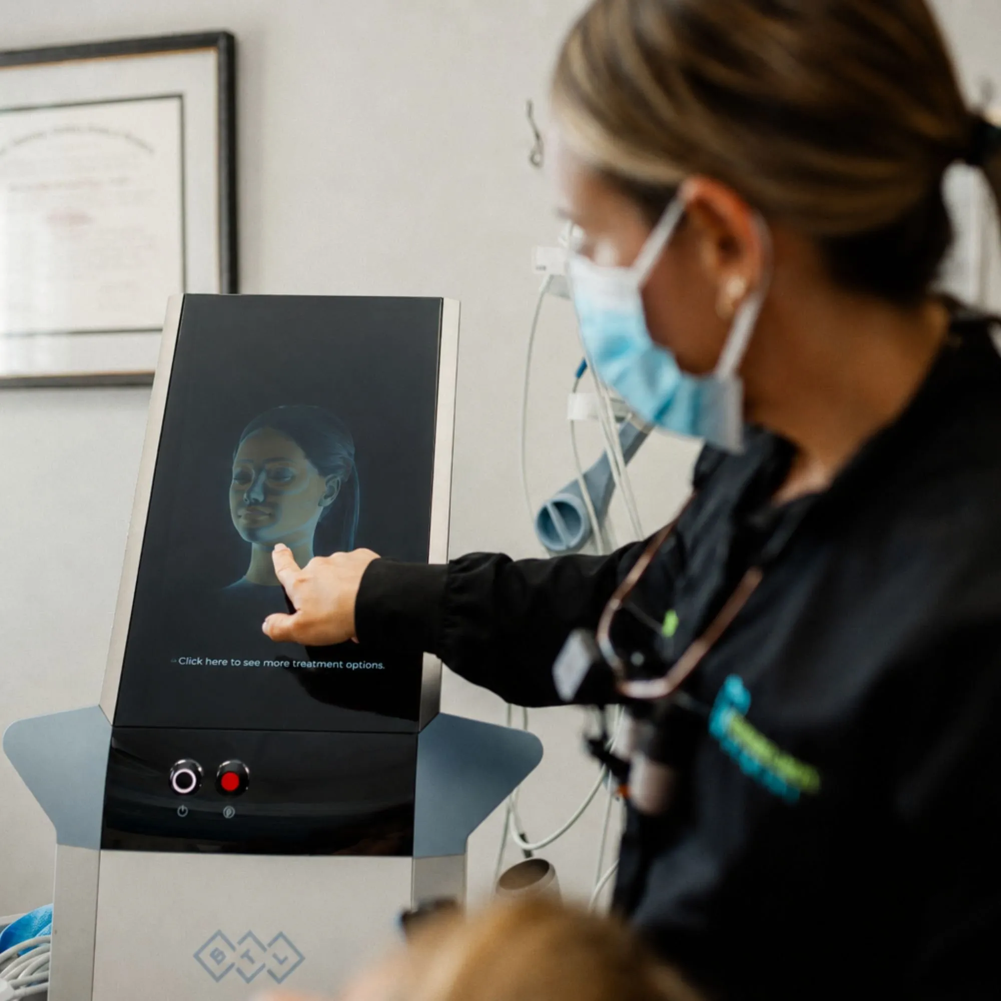 Team member reviewing a facial aesthetics scan on screen with a patient